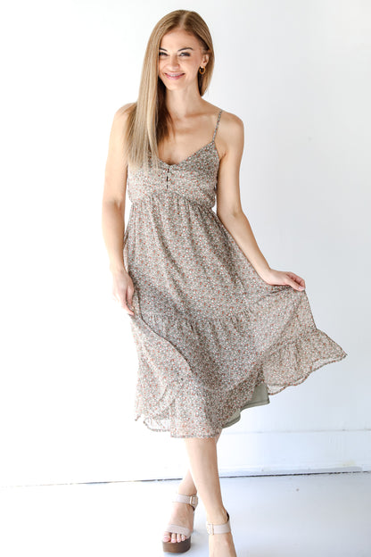 model wearing a floral midi dress with heels