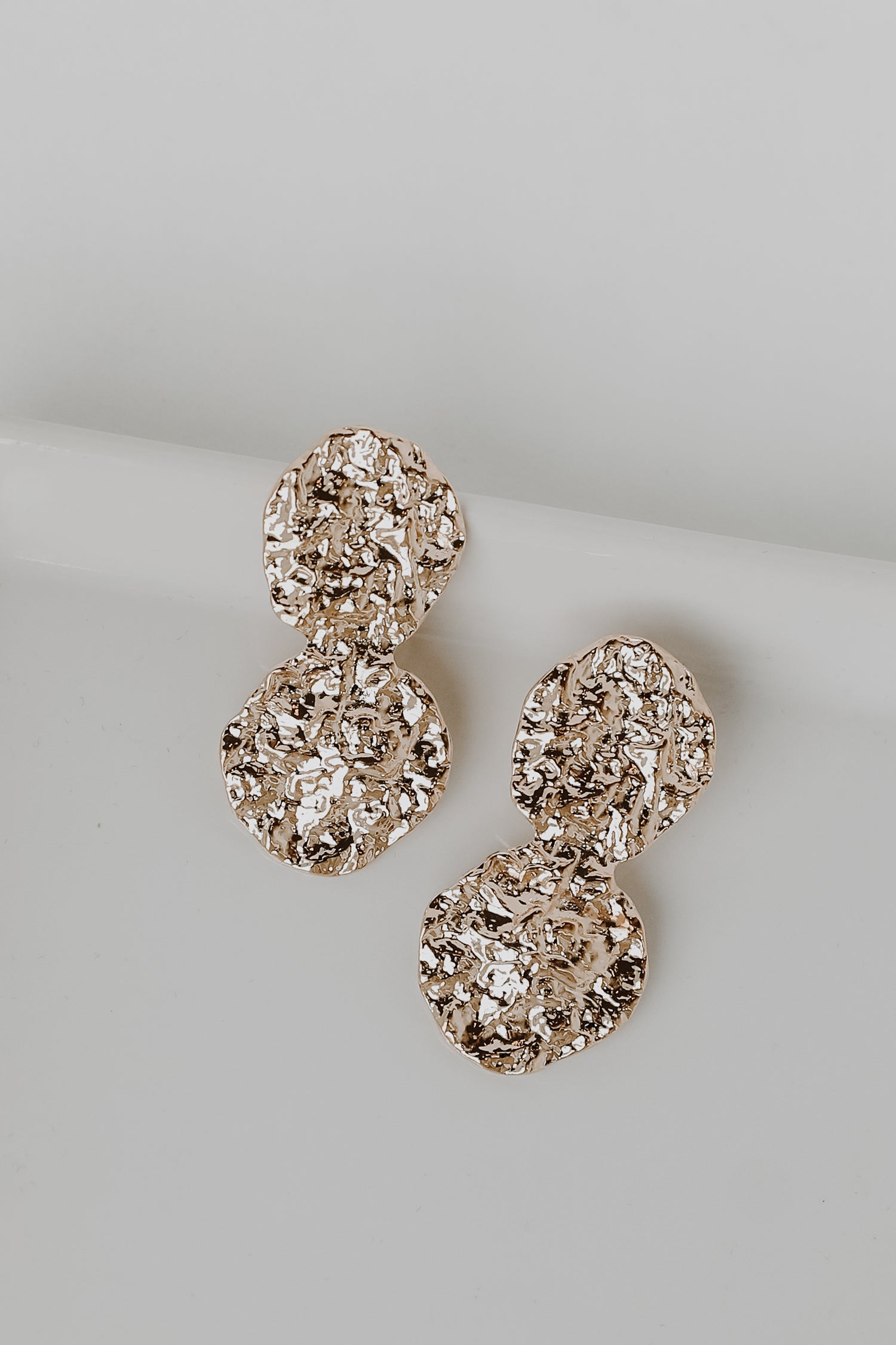 Gold Hammered Drop Earrings flat lay