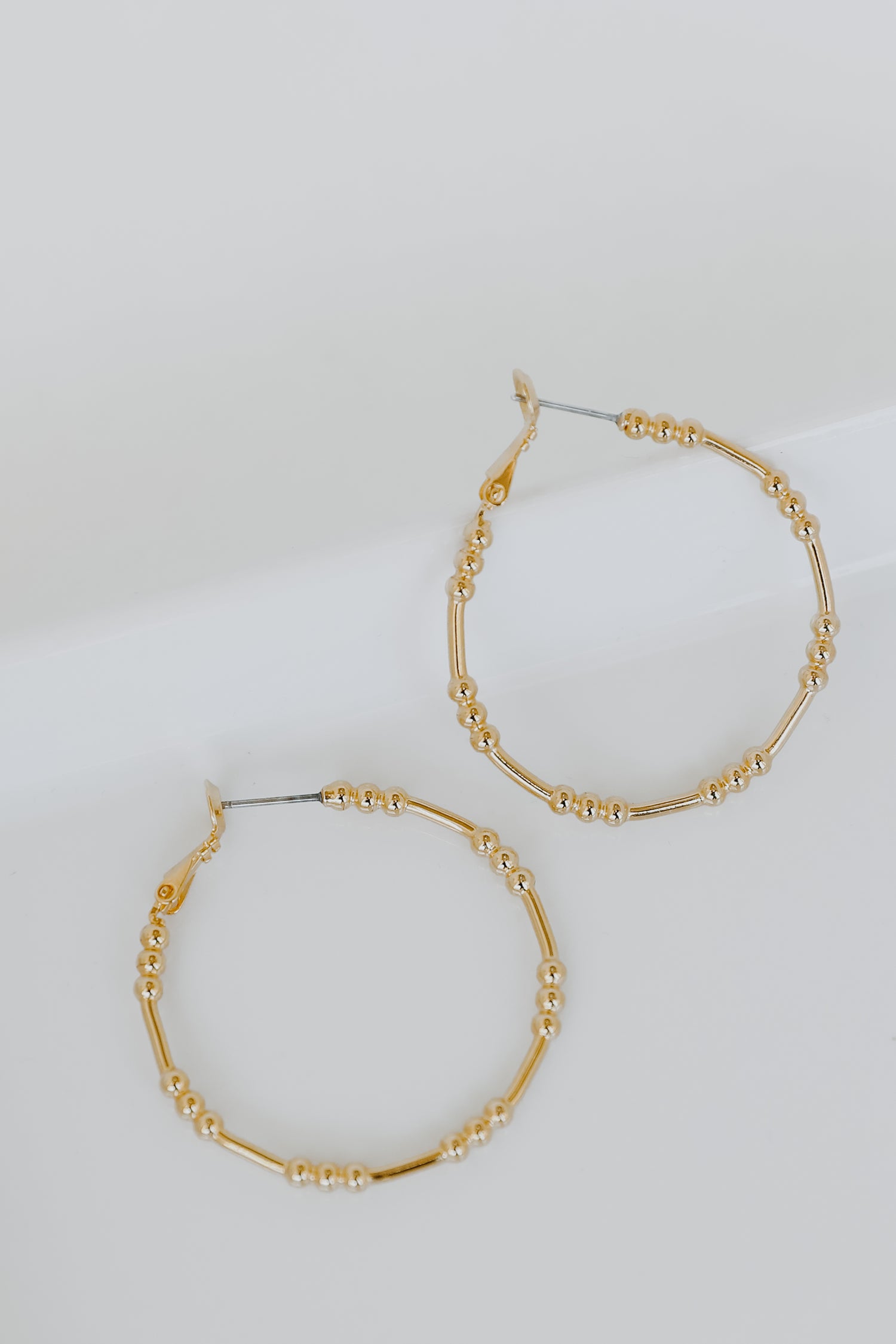 Gold Ball Hoop Earrings flat lay