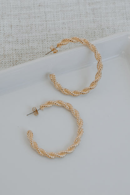 Gold Twisted Hoop Earrings flat lay