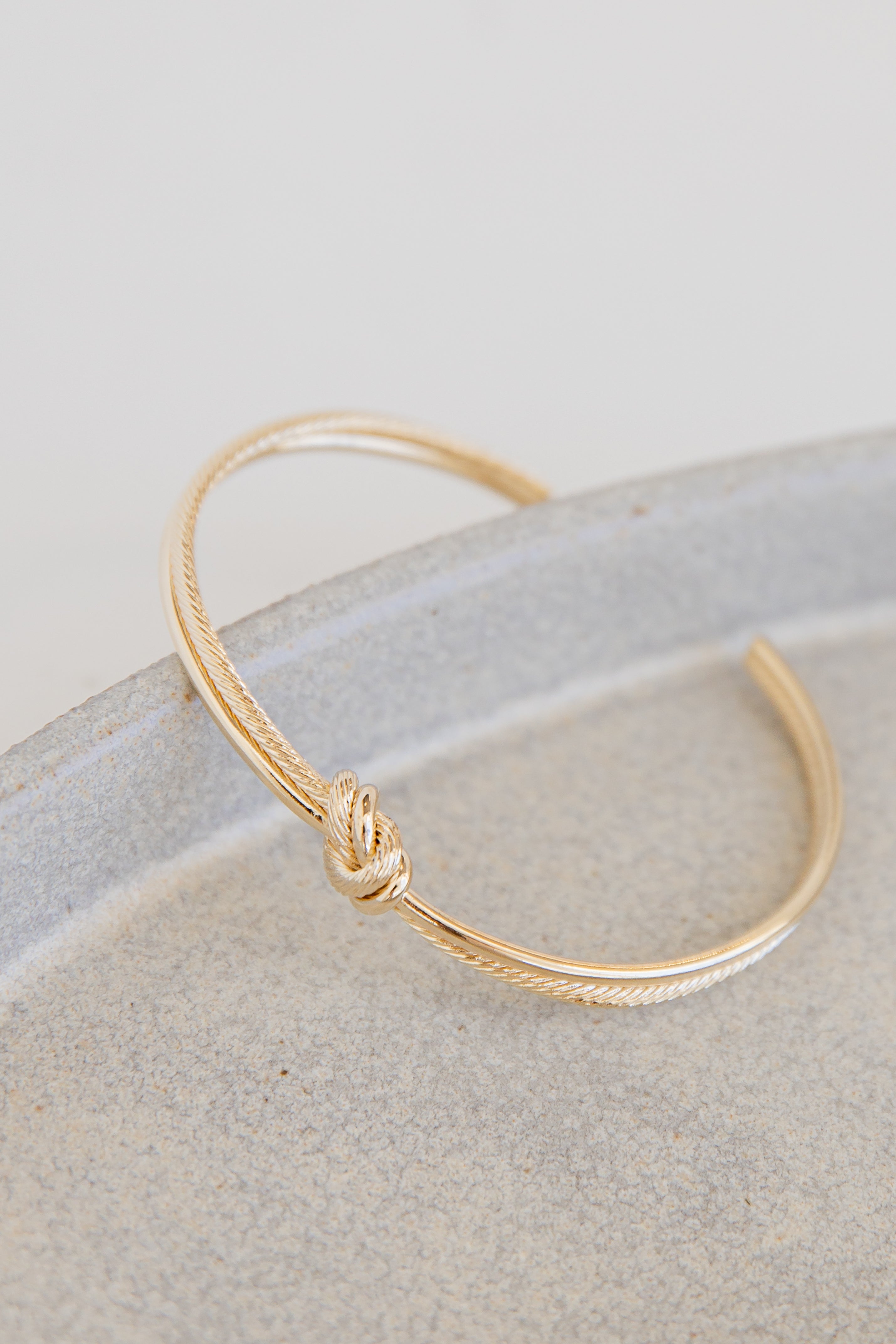 Gold Knot Cuff Bracelet flat lay