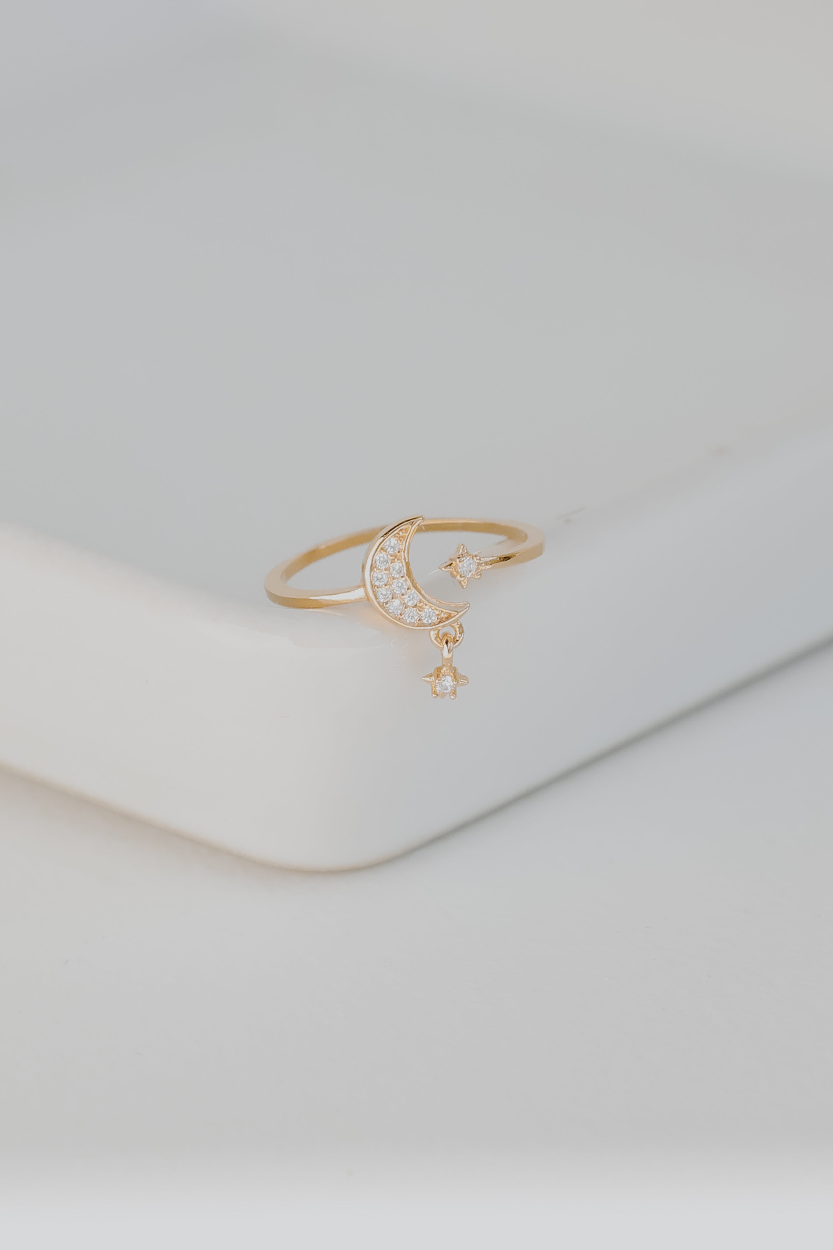 Gold Rhinestone Star + Moon Ring flat lay