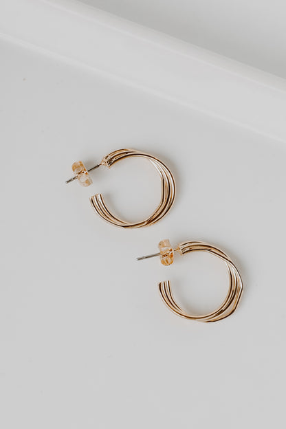 Gold Twisted Hoop Earrings flat lay