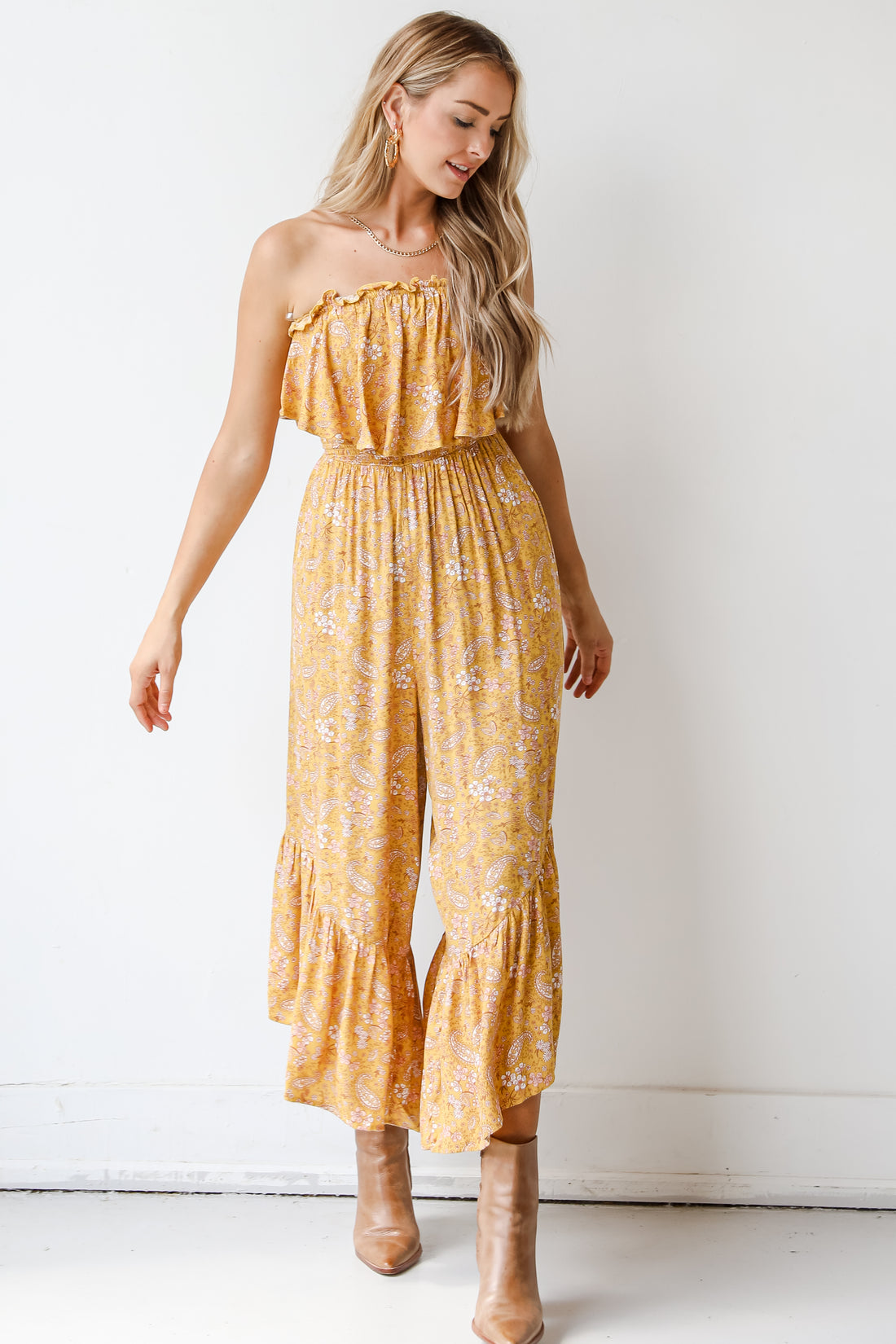 model wearing a yellow ruffle jumpsuit