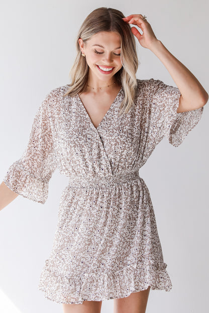 tan floral mini dress on model