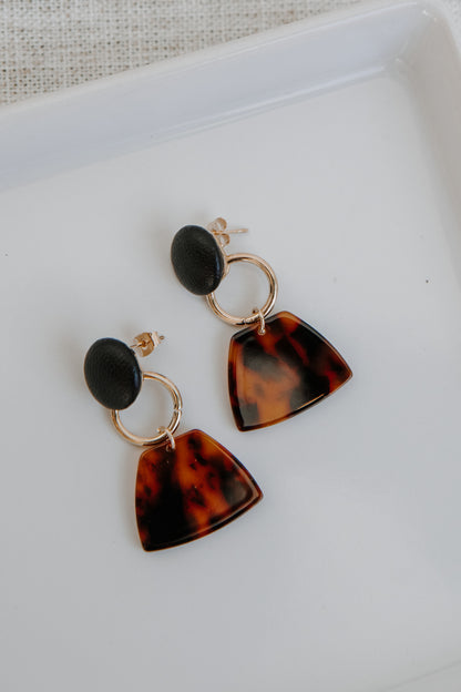 Drop Earrings in black flat lay